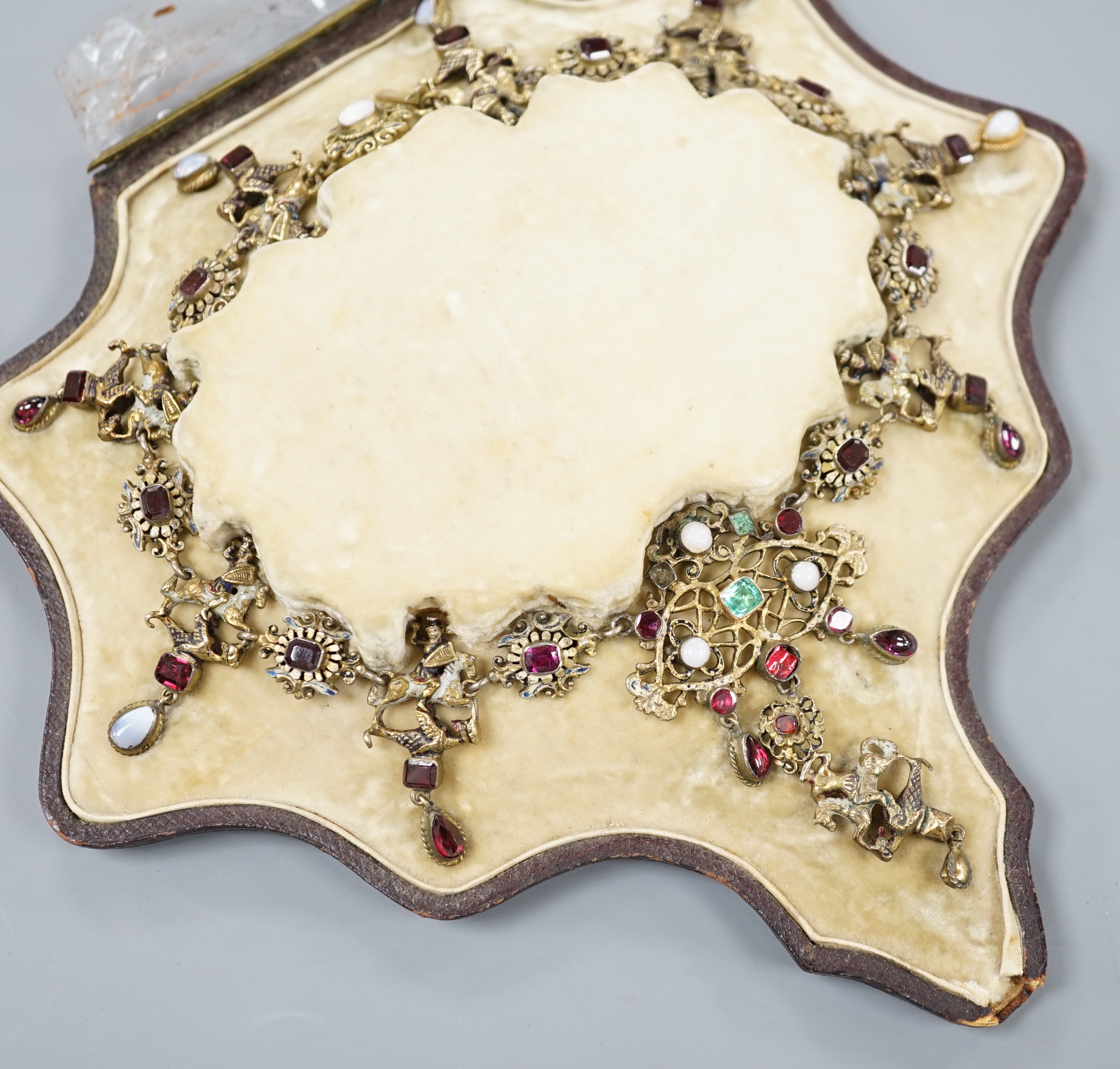 A 19th century Austro-Hungarian? gilt metal, gem, enamel and paste set drop fringe necklace, 36cm, in fitted box.